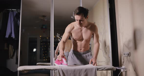 Bare Torso Man Ironing Clothe at Home alt