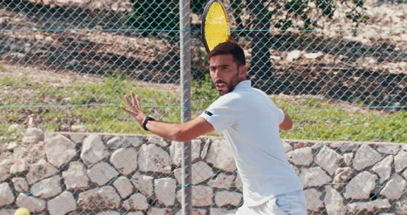 Slow motion of a tennis player hitting the ball during a tennis game alt