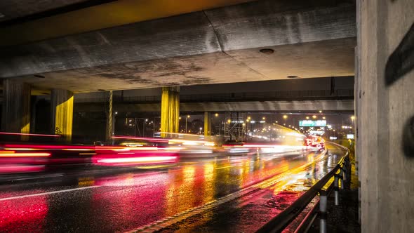 Rush Hour Traffic Under Bridge at Night