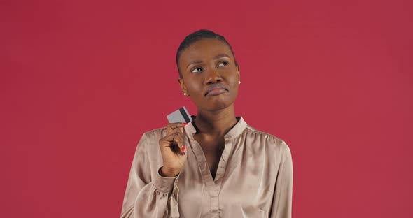 Portrait Afro American Woman Girl Client Consumer Buyer with Credit Card Stands Pondering Idea  alt