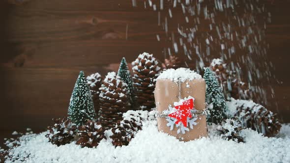 Christmas and New Year Background with Snow, Pine Cones, Present with Red Fir Tree. alt
