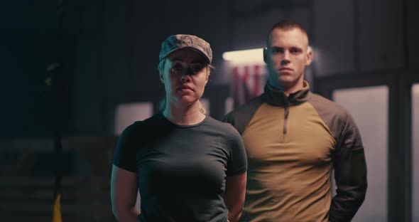 Male and Female Soldiers Looking at Camera alt