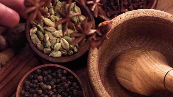 Wood Mortar and Star Anise Spice Species Falling in Slow Motion alt