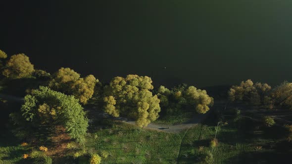 Flight To The Autumn Park Located On The Shore Of A Large Lake. alt