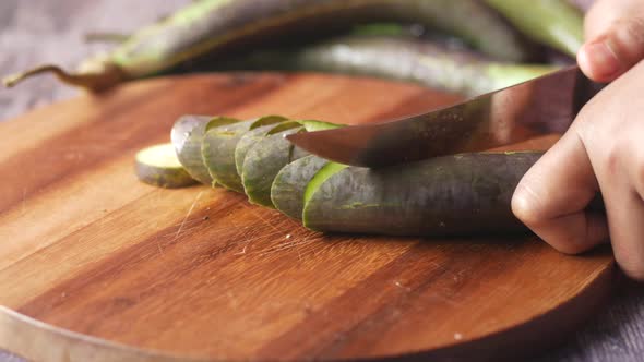 Cutting Eggplant on a Chopping Board alt