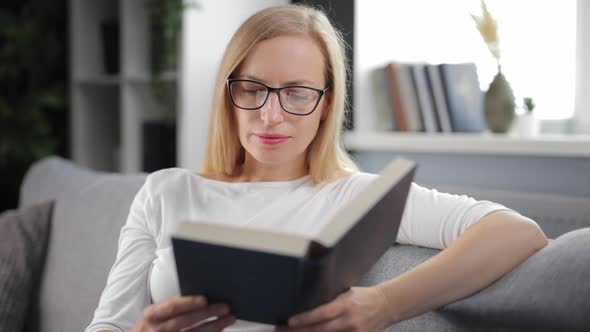 Woman Reading Book on Couch