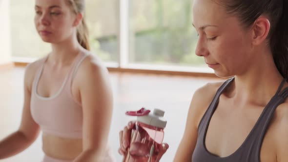 Caucasian Girl Drinking Water After Yoga alt