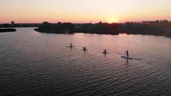 Aerial Drone View of People Paddling on a Sup Board in Kherson Ukraine Sunrise River