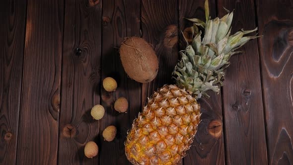 Closeup of Pineapple Coconut and Lychee on a Wooden Background alt