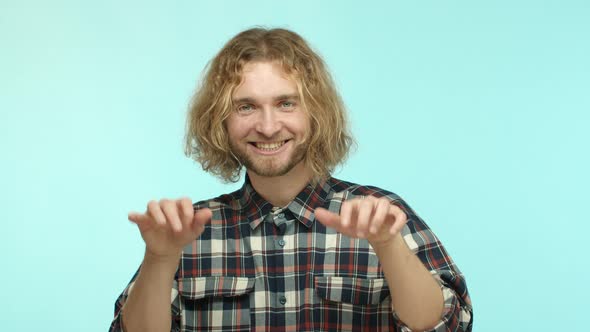 Slow Motion of Handsome Blond Man with Beard and Long Wavy Hair Playing on Air Piano and Smiling