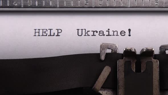 Typing phrase "HELP Ukraine !" on retro typewriter. alt