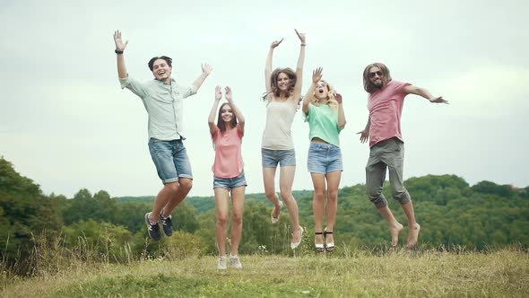 People Jumping Outdoors. Group Of Friends Having Fun In Nature alt