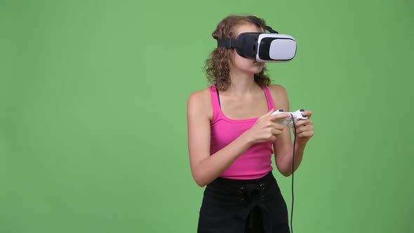 Young Beautiful Nerd Woman Playing Games and Using Virtual Reality Headset alt