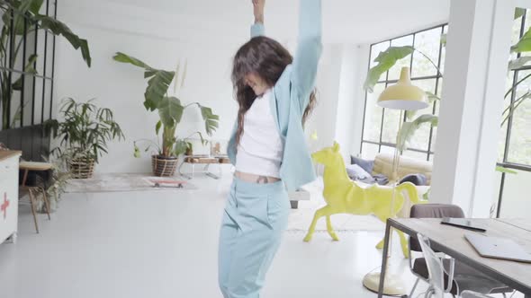 Young Latina Business Woman Dances Funny in Office alt