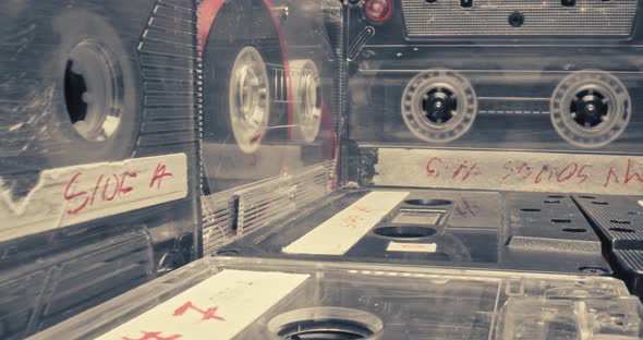 Player with spinning old audio cassette. Cassette and player. alt