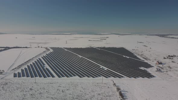 Aerial Perspective Solar Panel Farm Green Energy at Winter Snow Sunny Day Drone Shot of Ecology