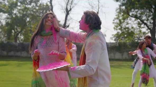 Happy Indian people playing Holi alt