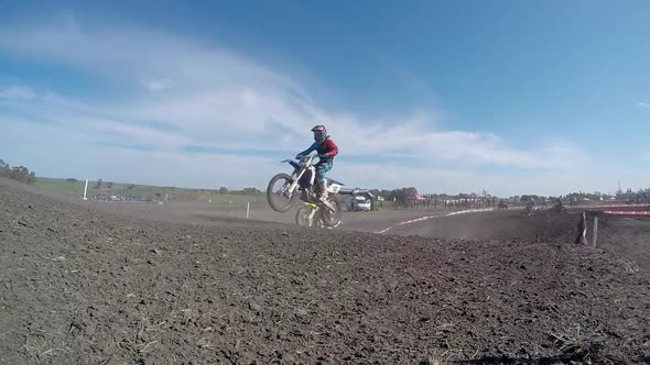 Men racing in a motocross motor sports race. alt