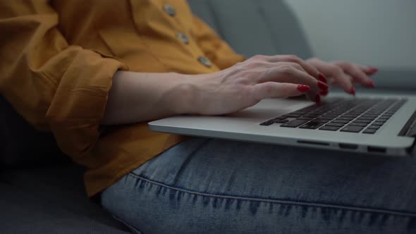 Attractive Young Woman Enjoying What She is Doing As She Works on Her Computer in Her Apartment alt