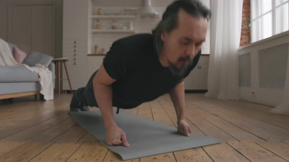 Middle Aged Man Doing Push-ups at Home