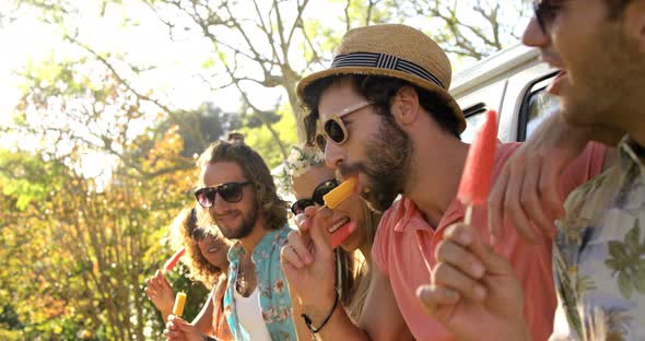Group of hipster friends enjoying and eating ice cream alt