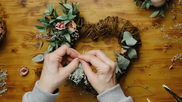 Hands Decorating Spring Floral Wreath alt