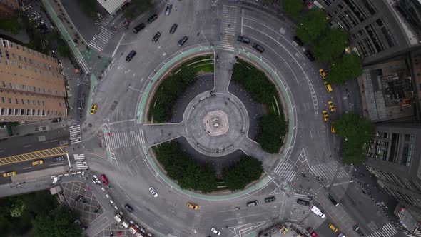 Aerial view above traffic driving around the Columbus Circle, in NYC, USA - rotating, top down, dron alt