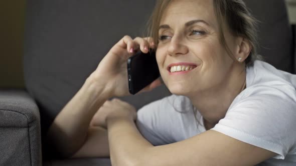 Portrait of a Beautiful Middle Aged Woman Talking on a Cell Phone