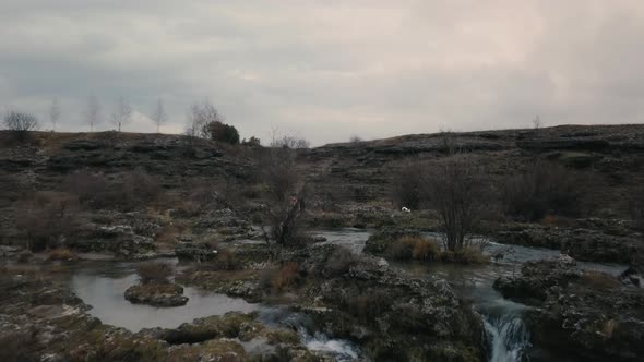Aerial view of Man  walking through the stone of Niagara Waterfall on the river Cijevna alt