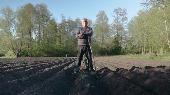 Villager Standing on the Field with Hoe