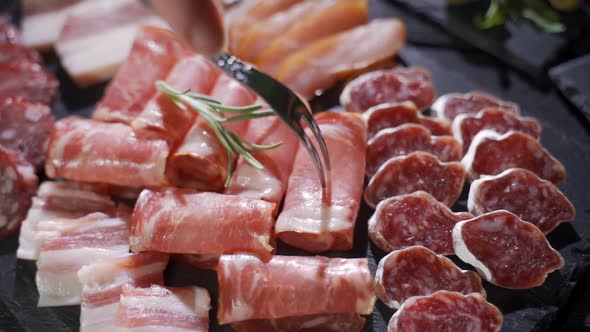 Assorted Deli Meats, Ham, Salami, Bacon and Tomatoes on the Black Stone Tray alt