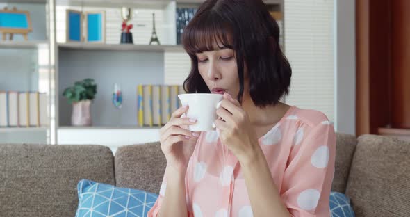 Asian pretty young woman happy while drink hot coffee