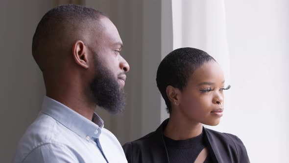 Two Business Partners Colleagues Adult African Man and Young Woman Standing in Office Looking Out alt
