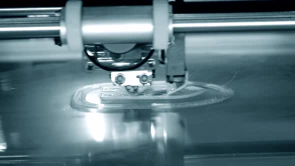3D Printer Works and Creates an Object From Hot Molten Plastic Closeup alt