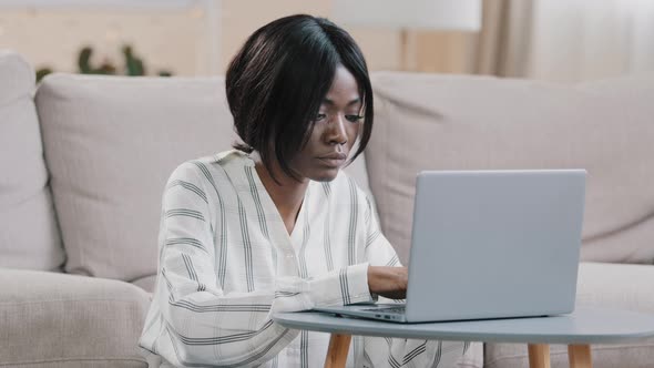 Focused Young African American Woman Freelancer Typing on Laptop Working Remote at Home Girl alt