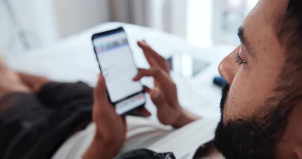 Man Scrolling Social Network on Phone