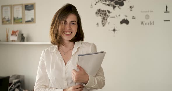 Cheerful Young Female Employee Holding Papers in Hands Portrait of Cheerful Woman in the Office Copy