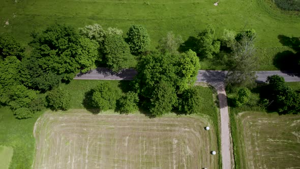 Aerial View Of Round Hay Bales In The Harvested Field. alt