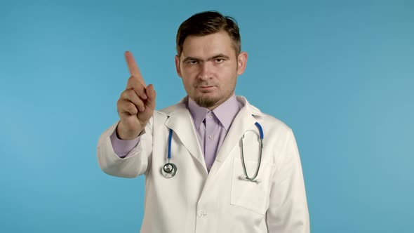 Portrait of Serious Doctor in Professional Medical White Coat Showing Rejecting Gesture Disapproving alt