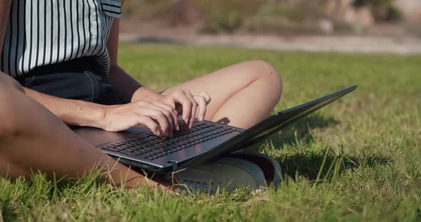 Close Up Hands of Freelance Woman Working Outdoor with Laptop Typing on Keyboard alt