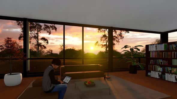 A Young Boy Sits In The Living Room In The Evening Sunset And Uses A Laptop