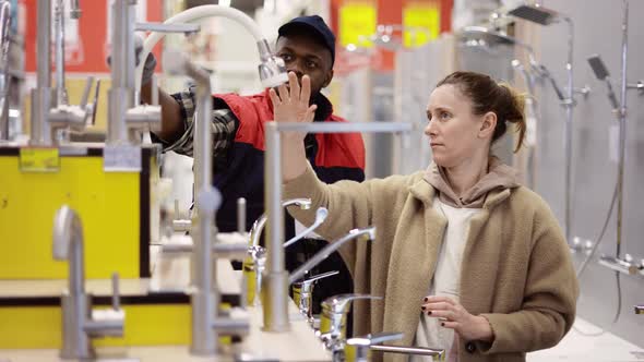 Shop Assistant Helps the Woman to Choose Bathroom Accessories alt