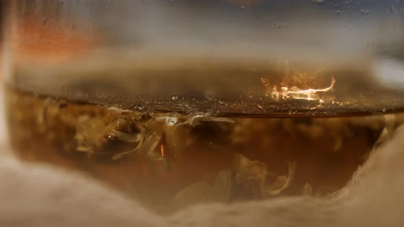 Macro View of Aromatic Infusion of Marigold Calendula Flowers in Transparent Teapot As Herbal alt