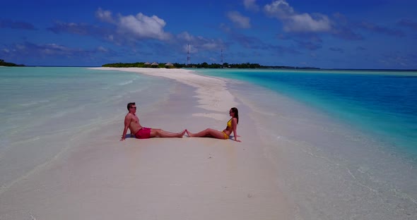 Young people married on vacation live the dream on beach on white sand background 4K alt