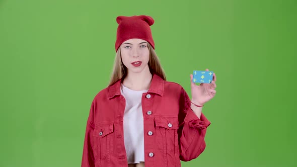 Girl Raises a Blue Card and Shows a Thumbs Up and Shows Ok. Green Screen. Slow Motion alt