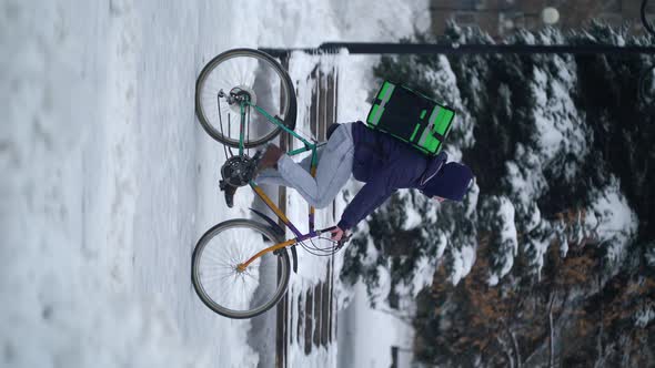 Courier Is Delivering Food with Backpack at Winter alt
