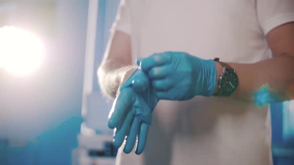The doctor puts on medical gloves. Dentist doctor. Hands. Close-up