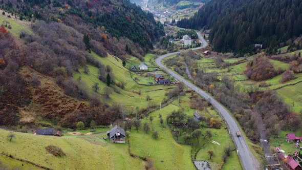 Small Village Along a Road in a Mountain Gorge Carpathian Mountains in Ukraine alt