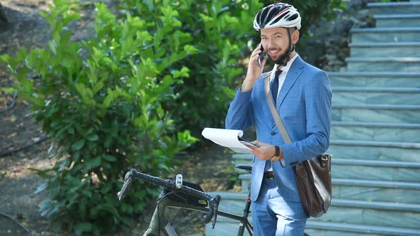 Businessman Analyzes Report And Talking On Phone
