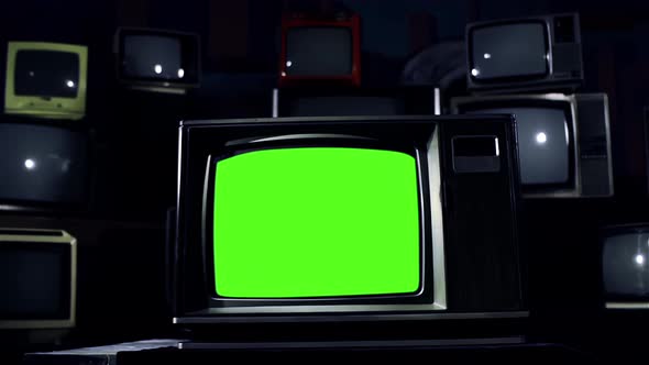 Old TV Green Screen in the Middle of Many TVs, Dark Tone. Dolly In. 4K.